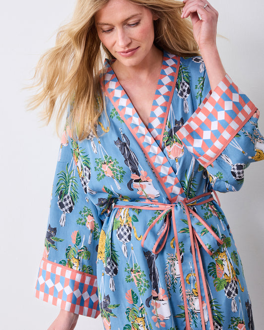 Slate blue cat-and-houseplant print robe with wide patterned cuffs and tied belt