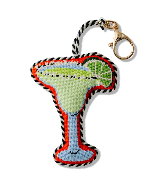 Margarita-shaped needlepoint bag charm with a gold-tone clasp and black-and-white twisted hanging loop.